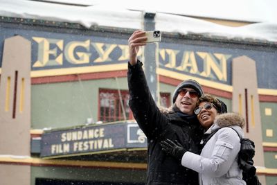 Couple taking a selfie outside Egyptian Theatre during Sundance Film Festival.