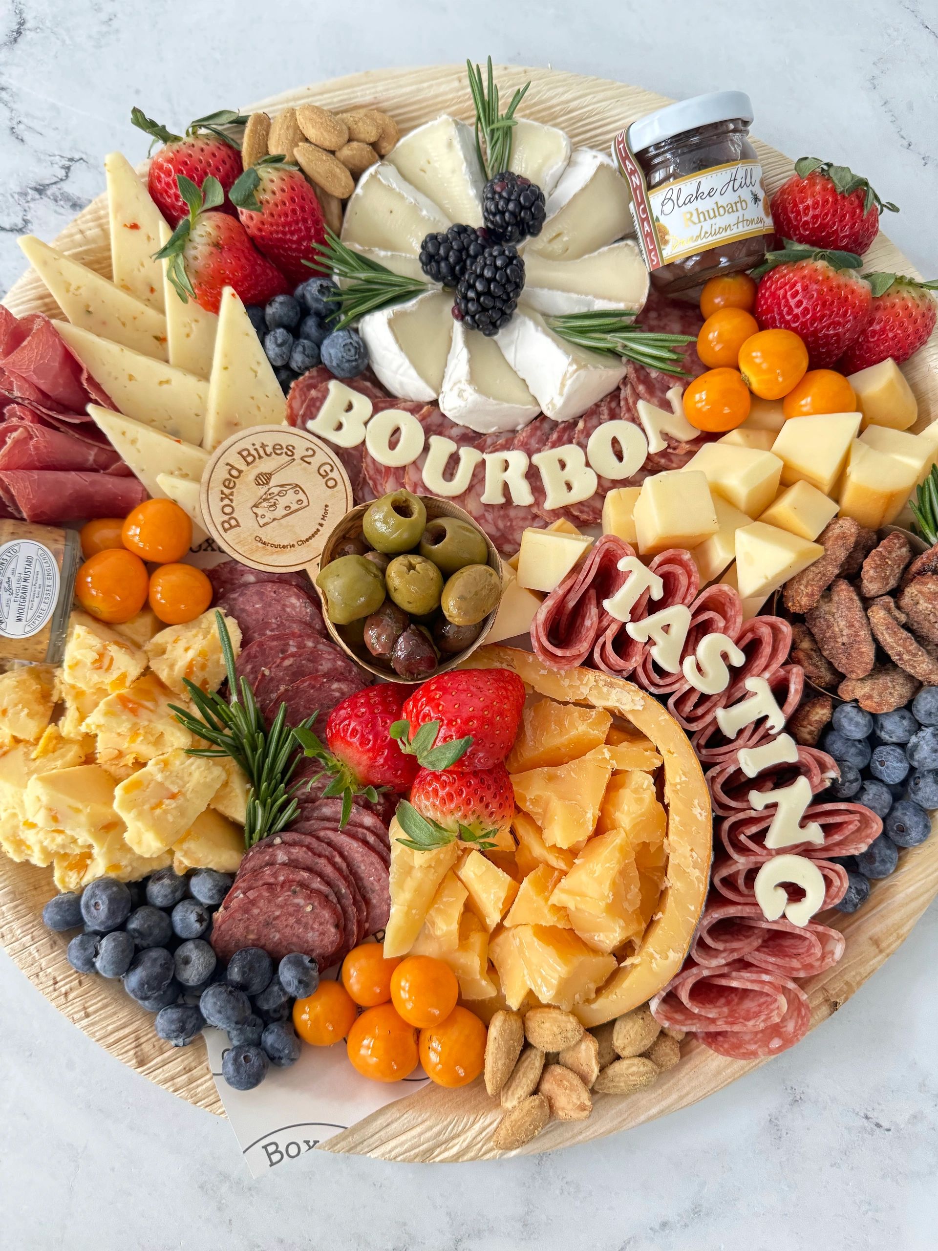 Bourbon tasting charcuterie board with cheeses, salami roses, olives and berries, Atlanta