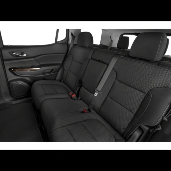 Black leather car back seat with seat belts.