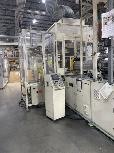 Industrial machinery inside a manufacturing facility with control panels.