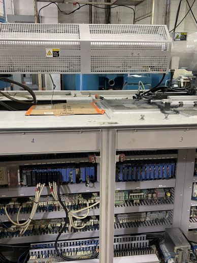 Industrial control panel with open doors revealing wiring and components.