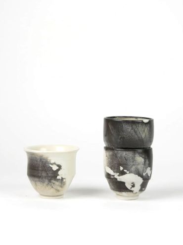 Three ceramic cups with black and white abstract patterns.