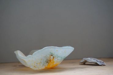 Artistic ceramic bowl with unique glaze on wooden surface.