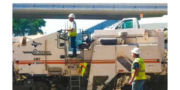 Equipment Operators working on the TexOp Construction Milling Machine.