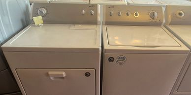A white washing machine and dryer set placed side by side.