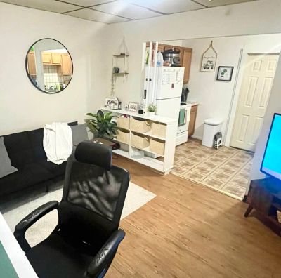 Cozy living space with black couch and black office chair.