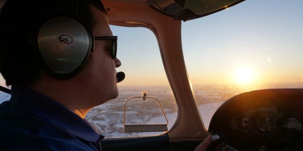 A Pilot Controlling a Flight During Dusk