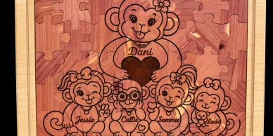 Wooden jigsaw puzzle featuring five smiling monkeys with names.