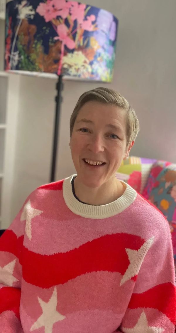 Smiling woman sitting on an armchair
