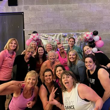 Group of women posing together, smiling and having fun.
