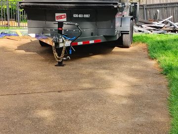 Our 11-yard dumpster positioned to be loaded. Rubber wheels locked & ready to be filled with renovat