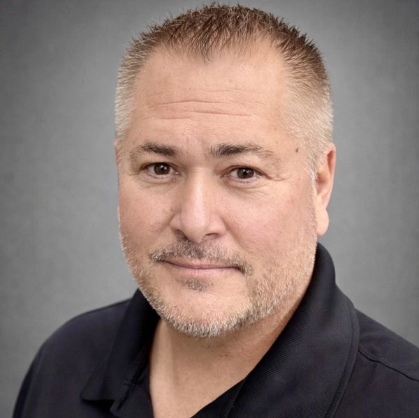 Portrait of a middle-aged man with short hair and light facial hair.