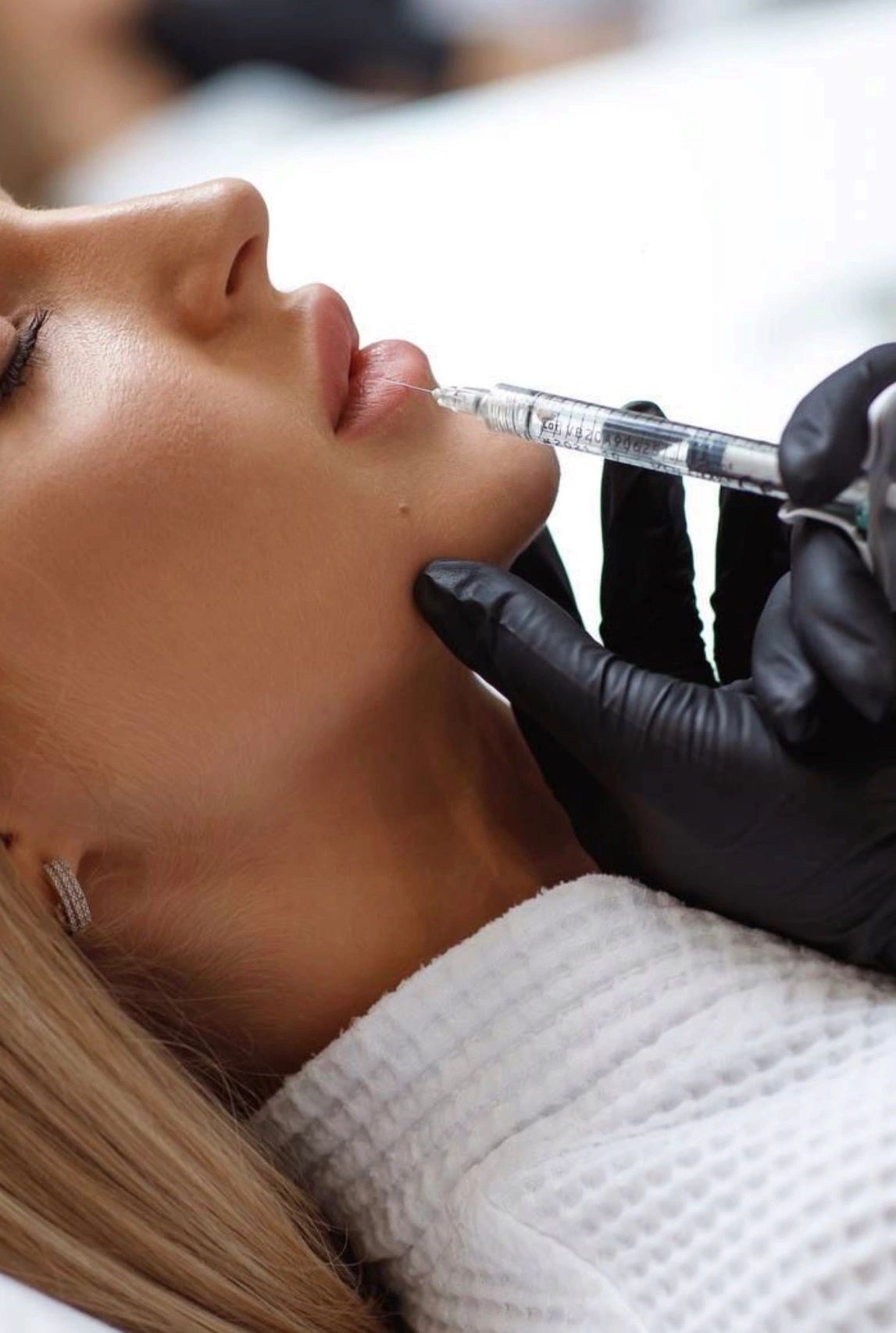 Woman receiving a lip injection.