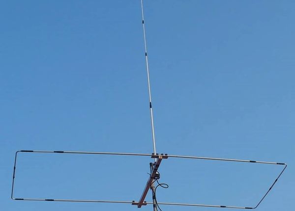 A metal antenna structure against a clear blue sky.