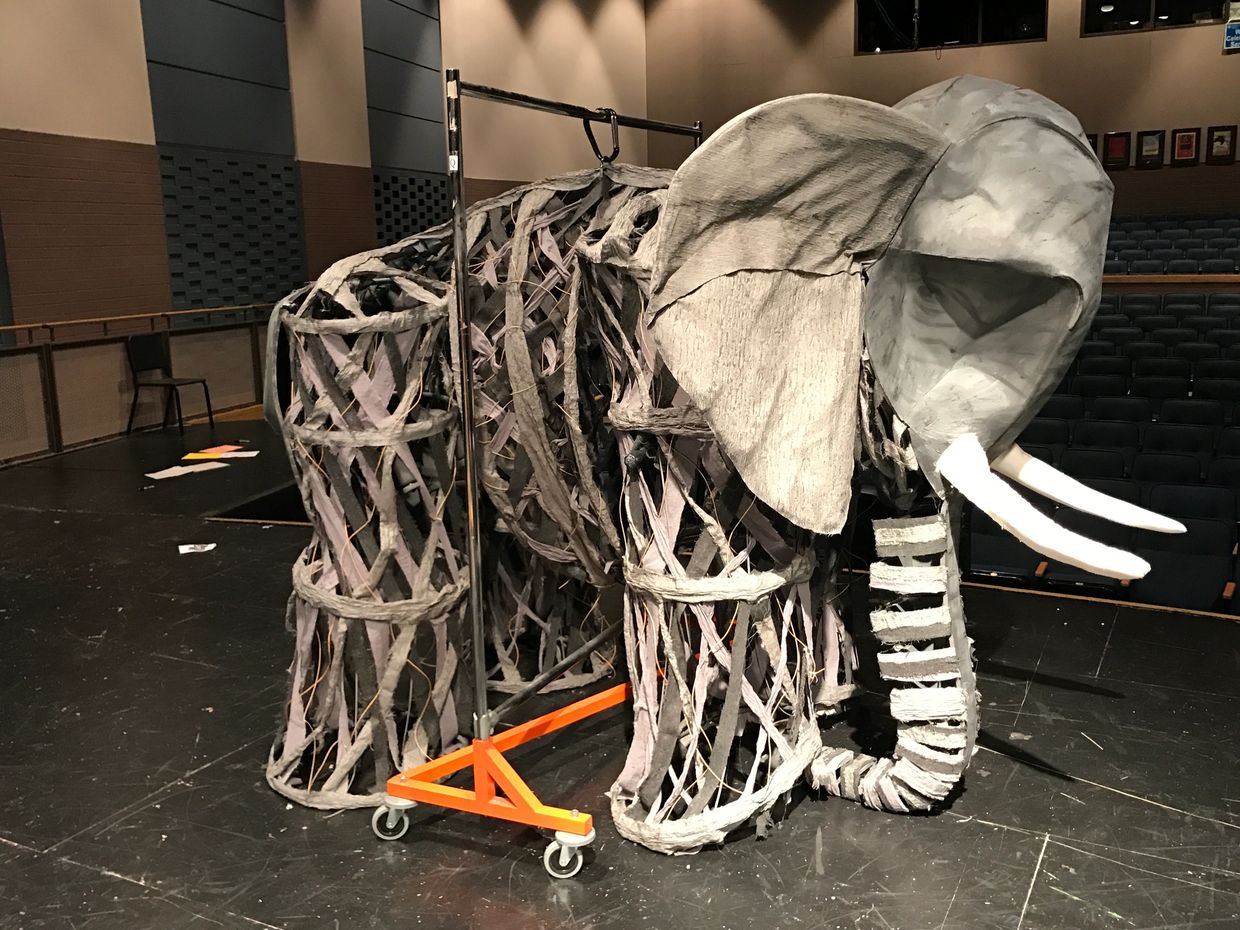 8’  tall elephant puppet hanging on a Z rack waiting for the five performers  to bring it to life.