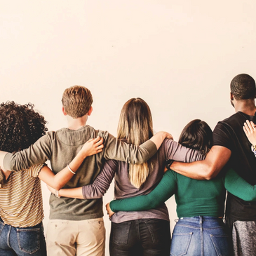 Group of diverse friends standing arm in arm, showing unity and support.
