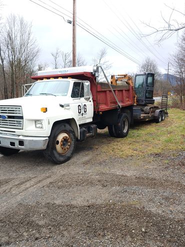 We name our equipment as opposed to giving them numbers. This is George the dump truck pulling Annie