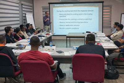A group of people attending a presentation on inspection procedures.