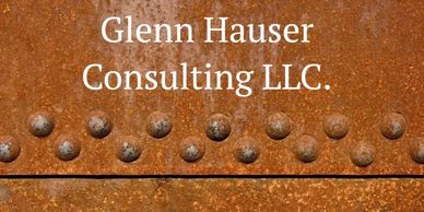 Rusty metal background with "Glenn Hauser Consulting LLC." text in white.