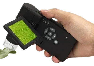 Handheld device with screen showing a green field, held in a person's hand.