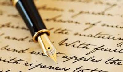 A close-up of a fountain pen writing on paper.
