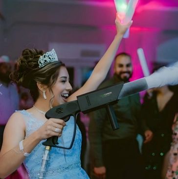 Photo of a bride holding lighted sticks and CO2 club cannon dancing during her wedding.