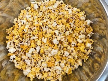 A bowl of freshly popped popcorn.