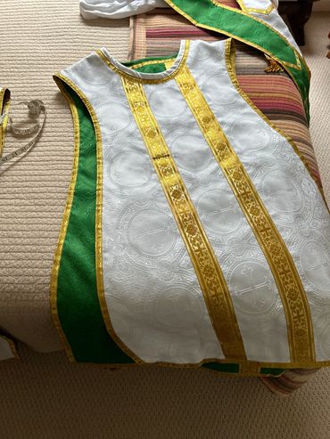 White religious vestment with gold and green accents.