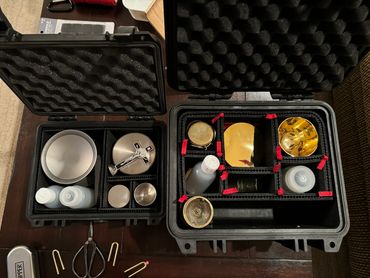 Religious items organized in protective foam cases.