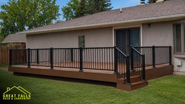 Custom Trex composite deck with black aluminum railing professionally built in Great Falls, Montana.