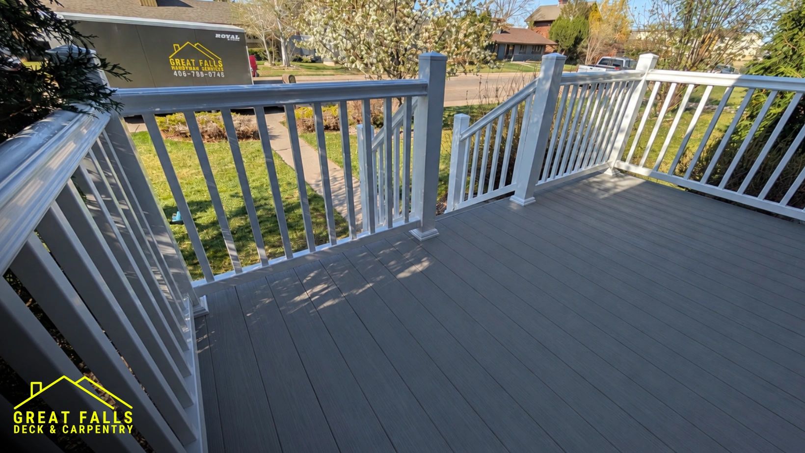 Newly installed composite deck with white railing.