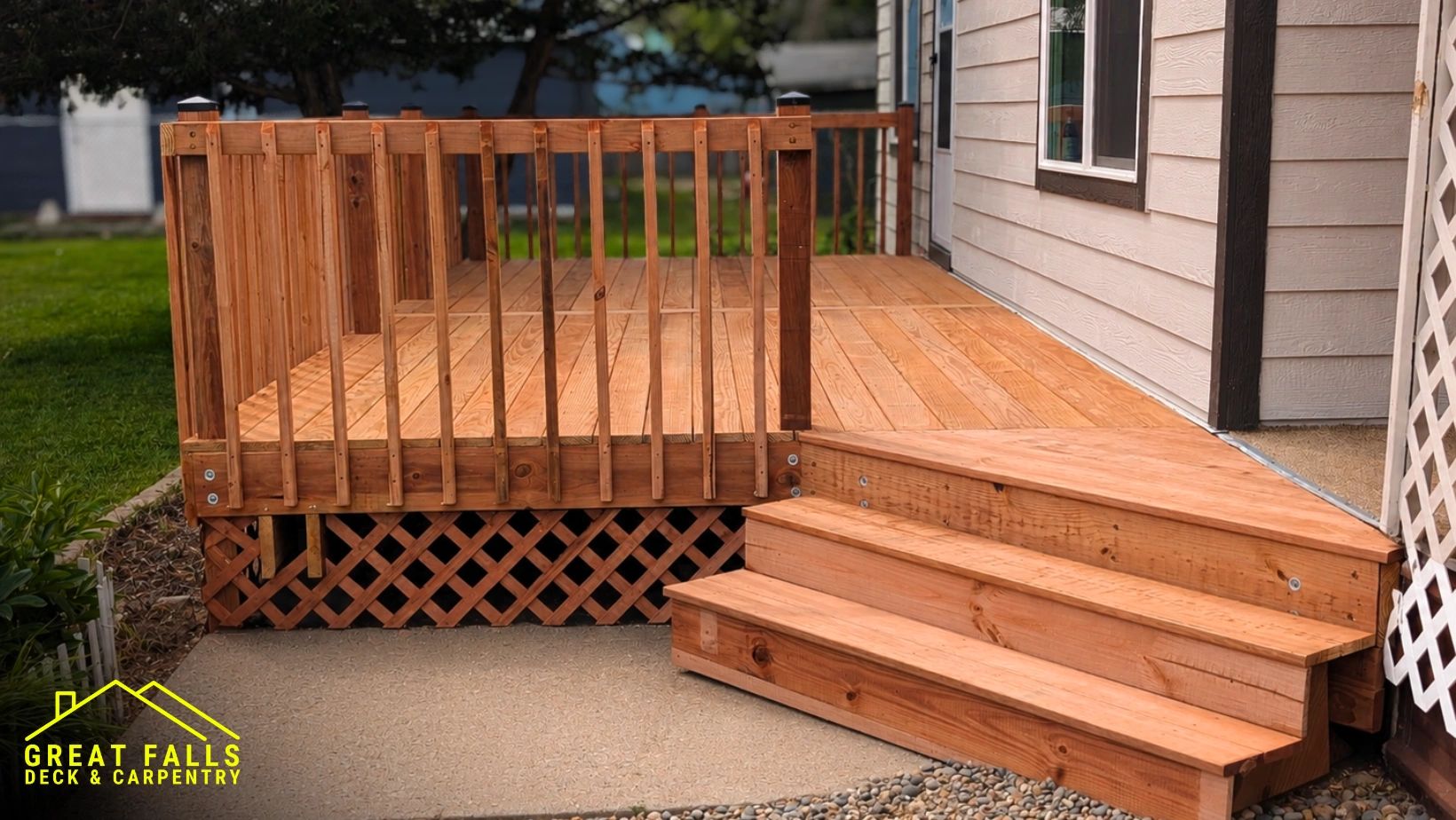 Newly built wooden deck and stairs beside a house.