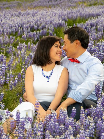 A couple relaxing in a field of lupine, photography in Northern California.