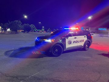 Police SUV with flashing lights at night.