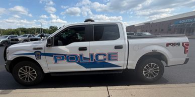 Side view of a police pickup truck.