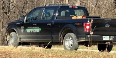 Black Ford pickup truck labeled as officer vehicle.