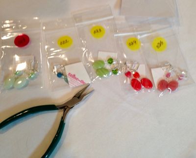 Affixing  numbers to earrings before they are logged in and given permanent numbers and prices.