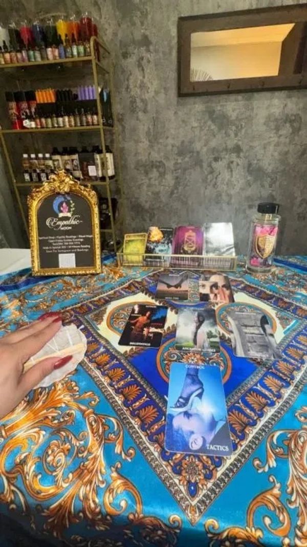 Tarot card reading setup with candles and spiritual items.