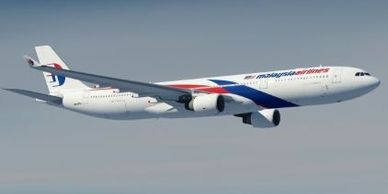 Malaysia Airlines airplane flying in clear sky.