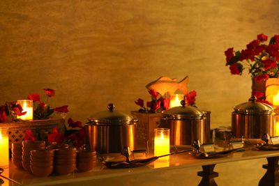 Buffet setup with warm lighting and floral decorations.