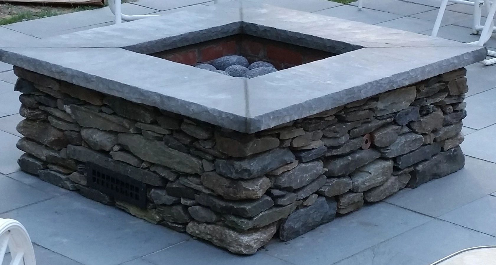 Stone gas firepit with bluestone capping