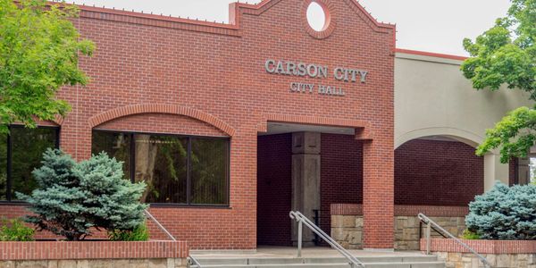 Carson City City Hall building with brick facade and greenery.