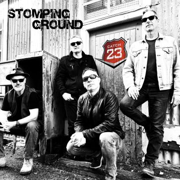 Black and white band photo with 'Stomping Ground' and 'Catch 23'.