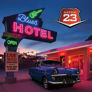 Neon-lit Blues Hotel sign with classic car at dusk.