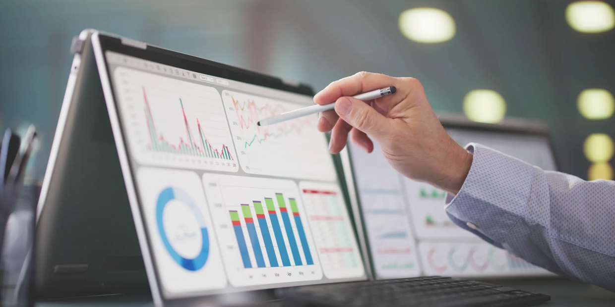 A person analyzing data charts on a tablet with a stylus.
