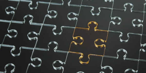 Black puzzle with one golden piece missing in the center.