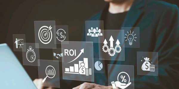 Businessman using laptop with floating ROI and financial icons.