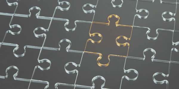 Black puzzle with one golden piece missing in the center.