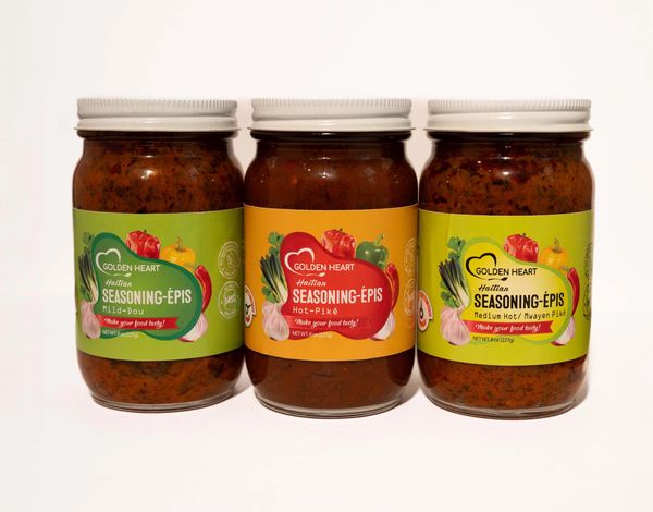 Jar of Taïna Haitian Trio Combo wet seasoning paste, vibrant Caribbean herbs visible