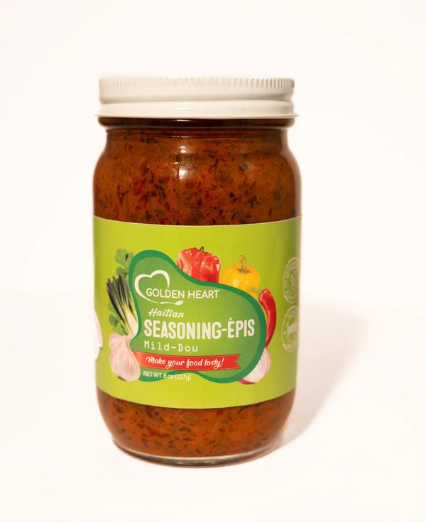 Jar of Taïna Haitian Epis Mild wet seasoning paste, vibrant herbs and spices inside